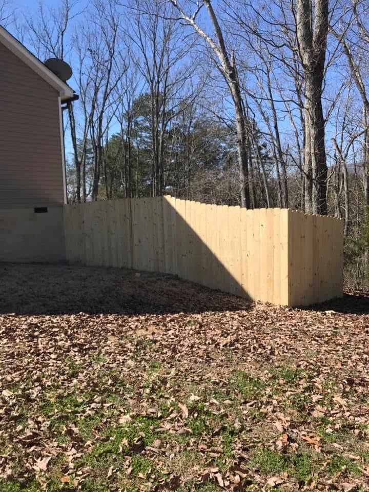 New wooden privacy fence installed beside a home