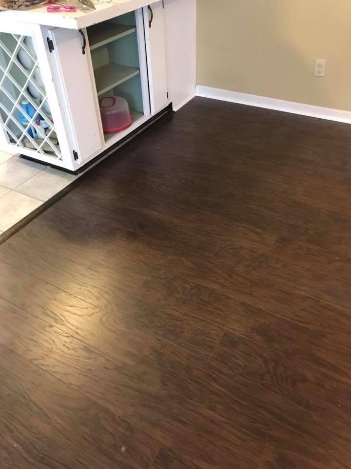 Dark flooring installed beside a white kitchen cabinet