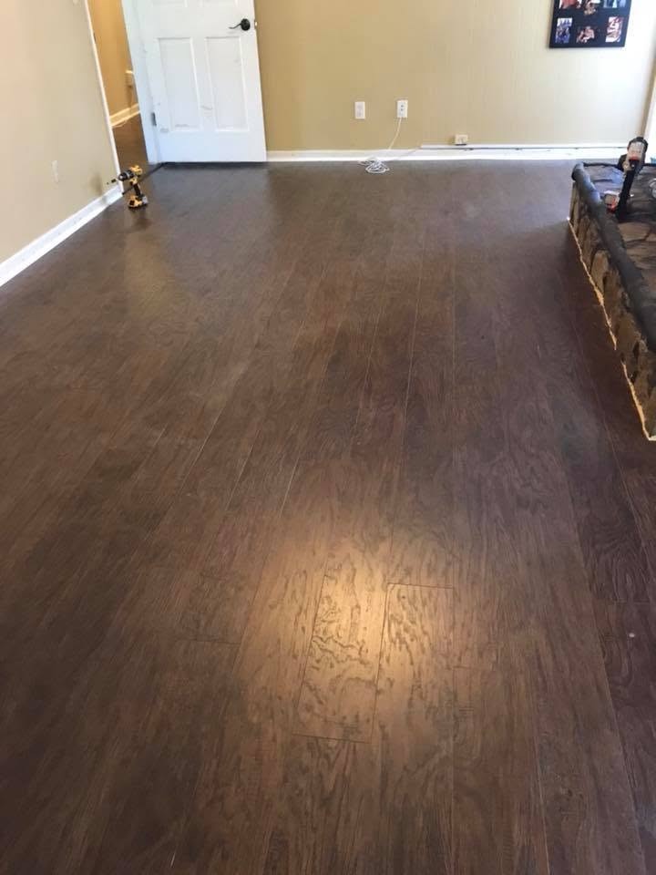 New dark flooring installed through a large living room